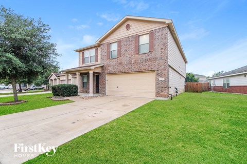a house with a driveway and a lawn