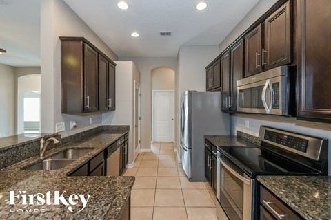 a kitchen with granite counter tops and stainless steel appliances