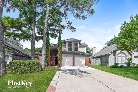 a white house with a driveway and a garage door