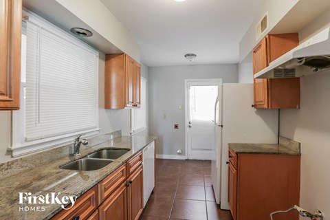 A kitchen with brown cabinets and a sink.