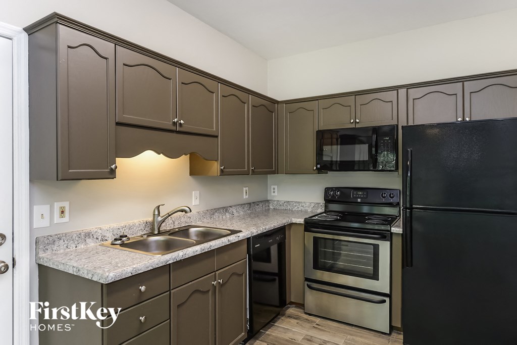 a kitchen with stainless steel appliances and granite counter tops