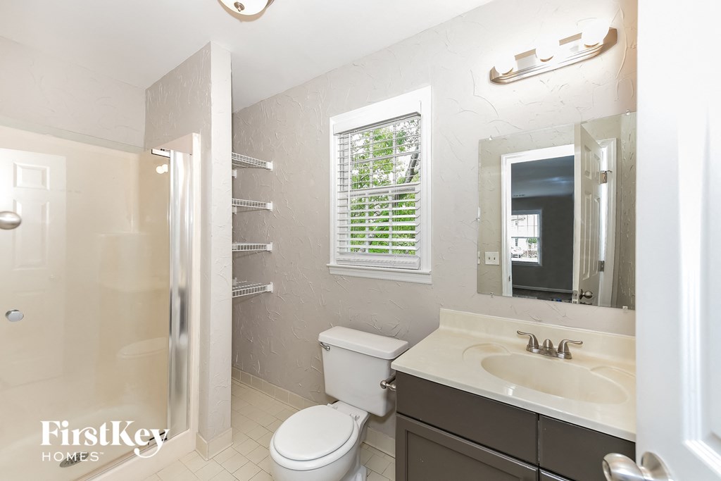 a bathroom with a sink toilet and a shower
