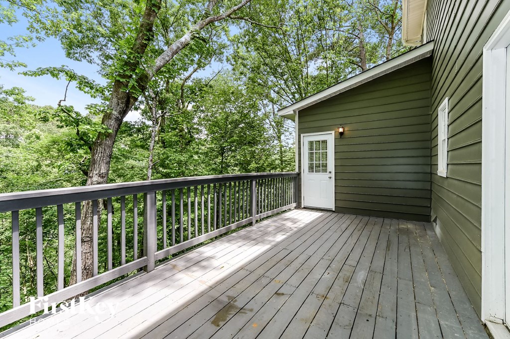 the view from the deck of a green house with trees