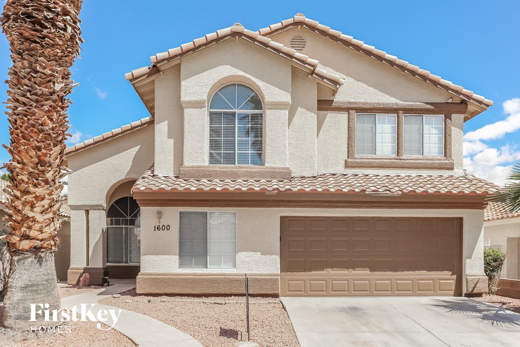 a house with a garage and a palm tree