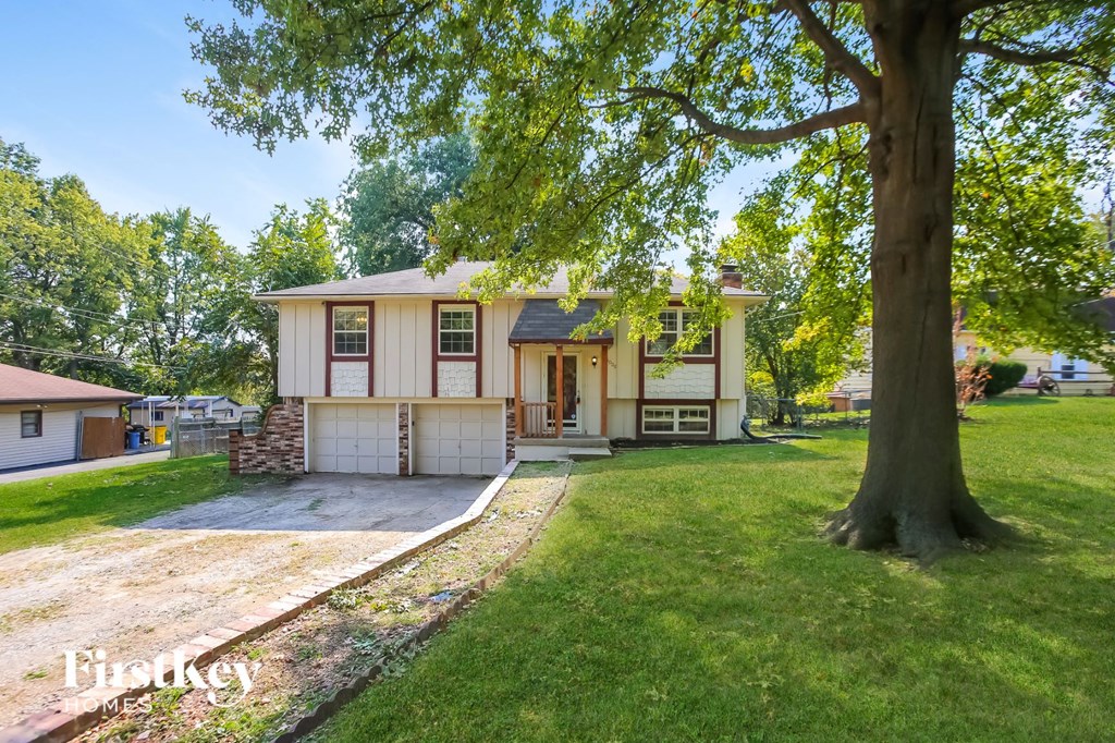 a white house with a large tree in front of it