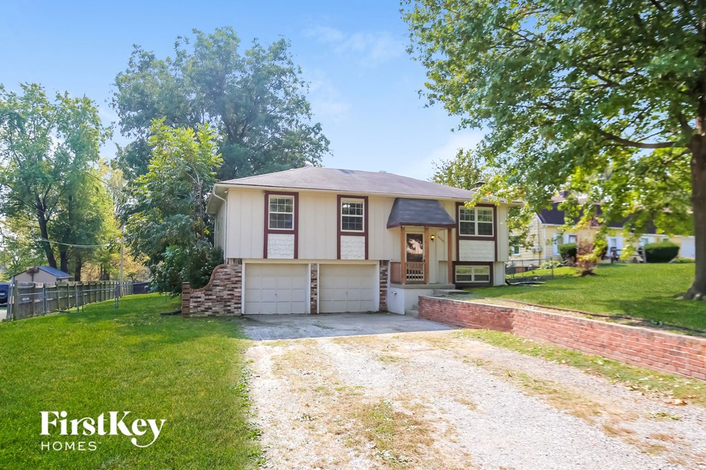 a white house with a driveway and a garage door