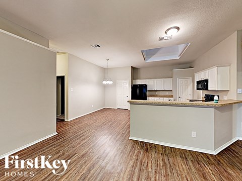 A kitchen with a wooden floor and a counter top.