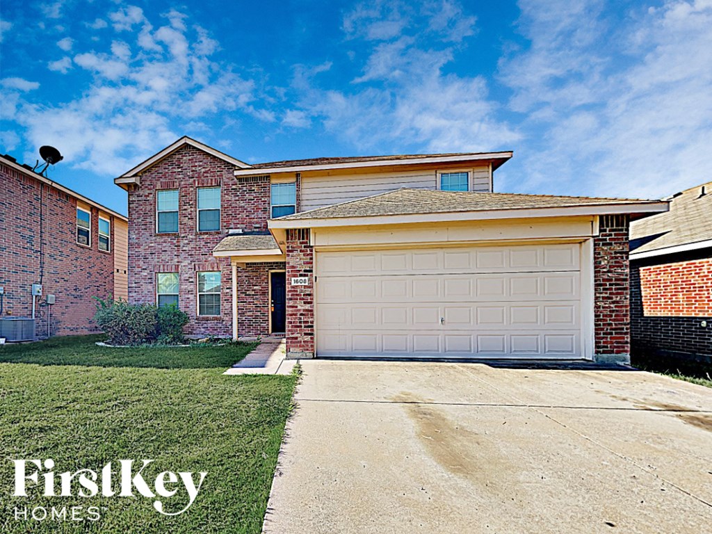 a brick house with a white garage door