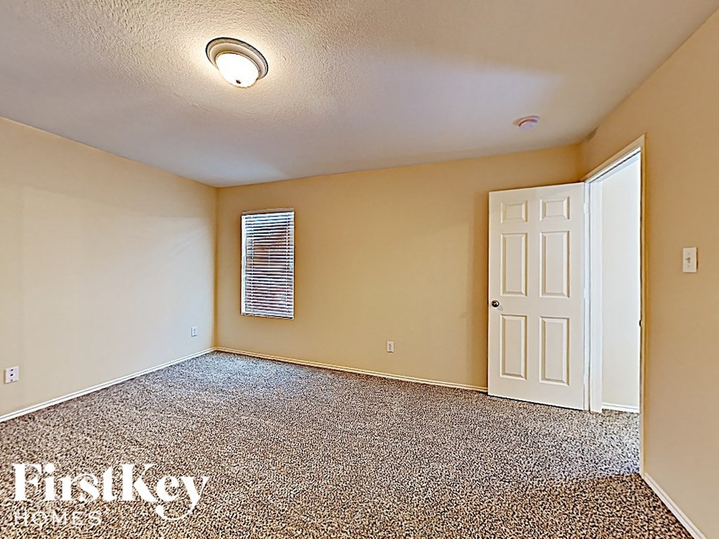 the living room of an empty house with a white door