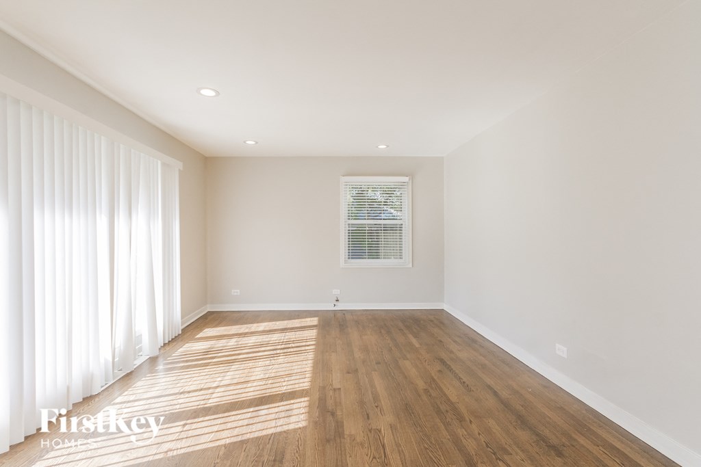 a living room with wood floors and white walls