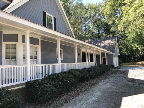 A house with a grey exterior and white trim.