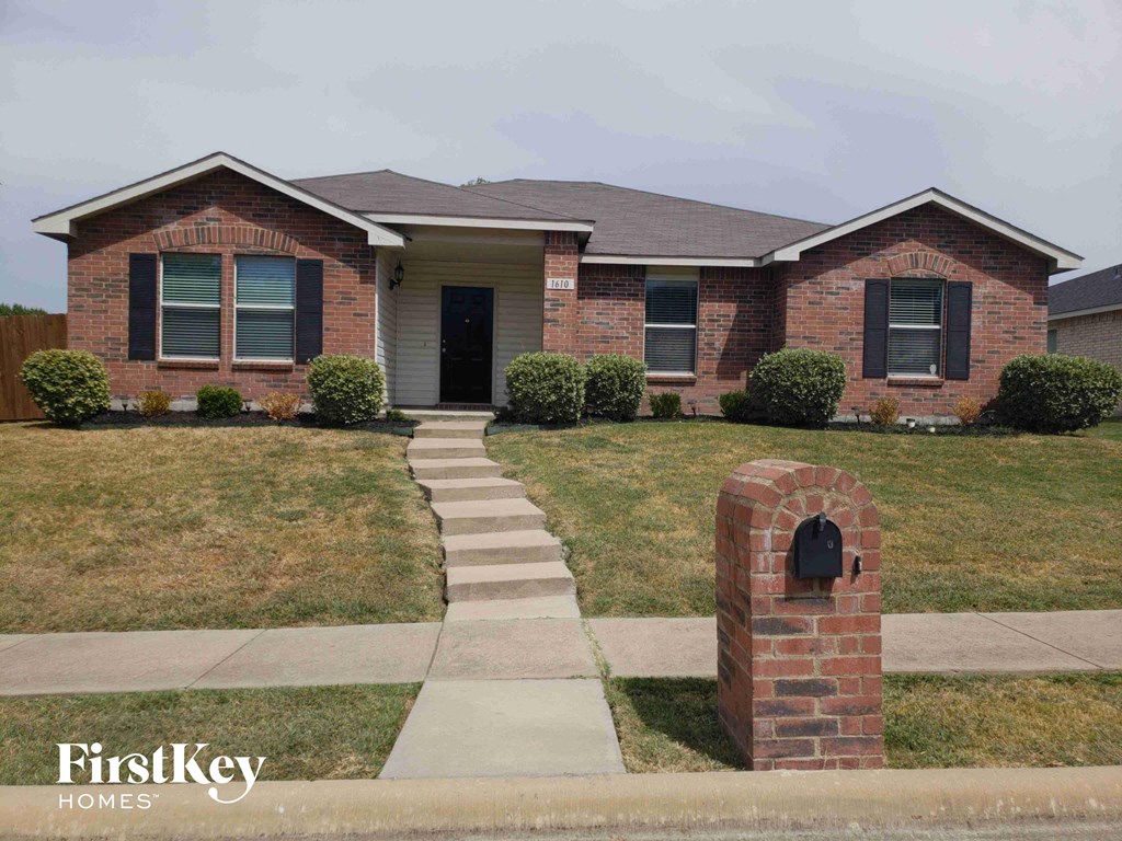 A brick house with a mailbox in front of it.