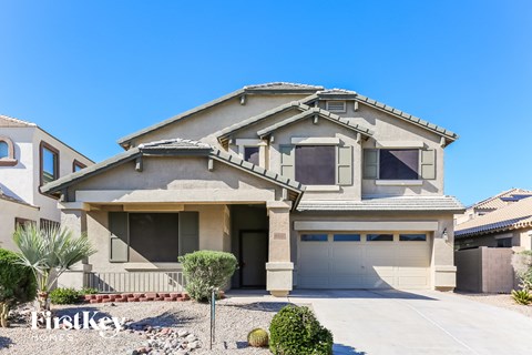 a house with a garage and a driveway in front of it