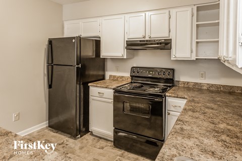a kitchen with stainless steel appliances and white cabinets