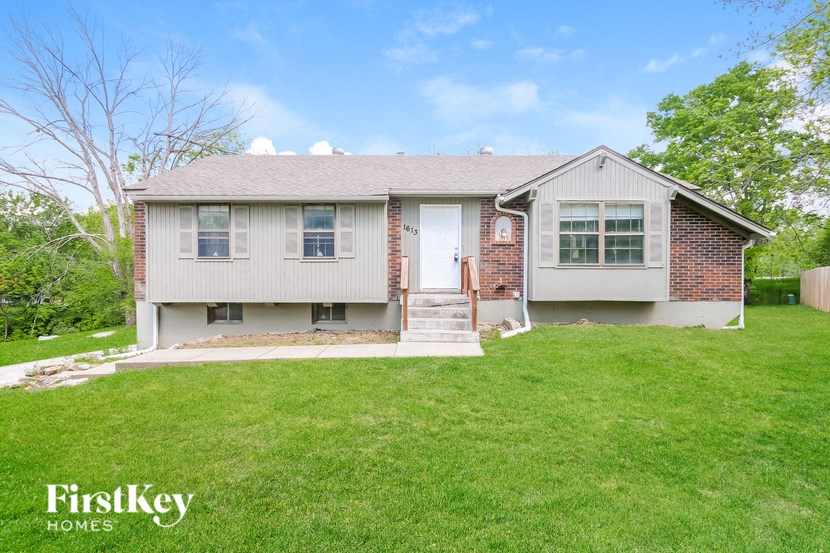 A house with a lawn in front of it.