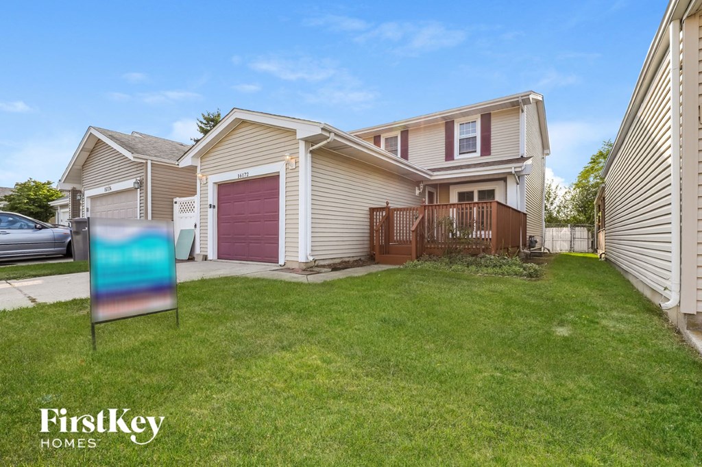 a house with a yard and a sign in front of it