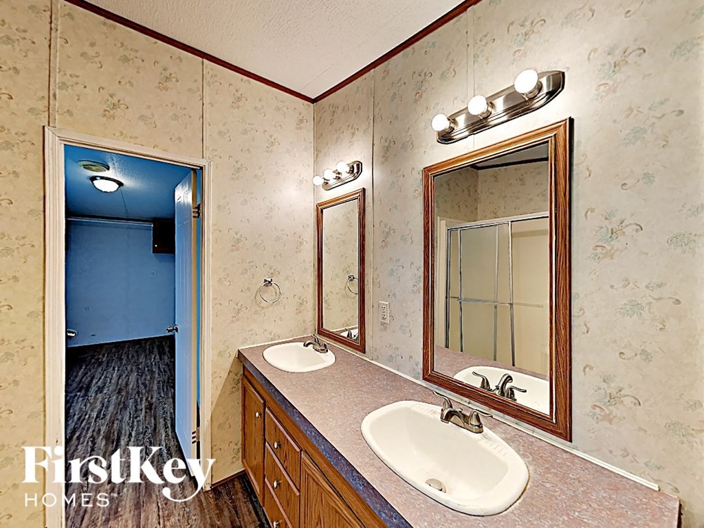 a bathroom with two sinks and a mirror