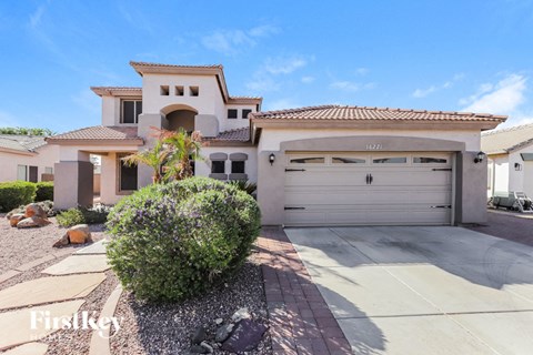 a house with a garage door and a driveway