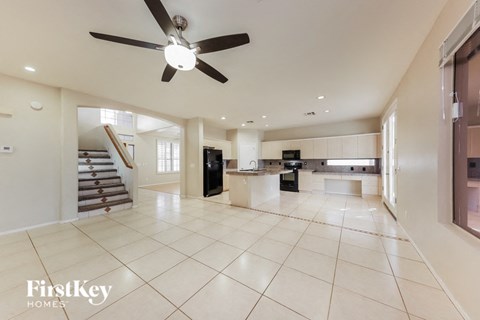 an open kitchen and living room with a ceiling fan