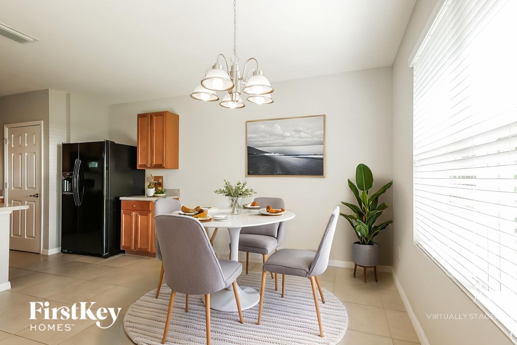 A modern dining room with a table set for four.