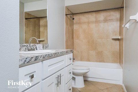 a bathroom with a sink and a toilet and a tub