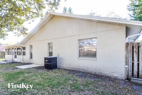 a white house with a trash can in front of it