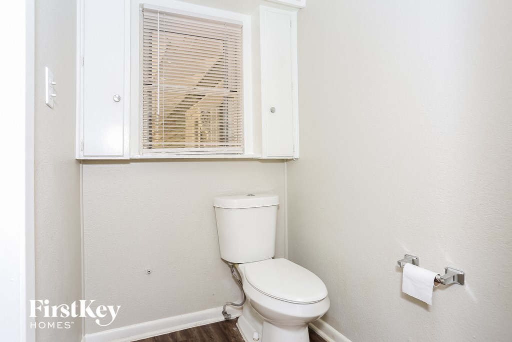 a small bathroom with a toilet and a window