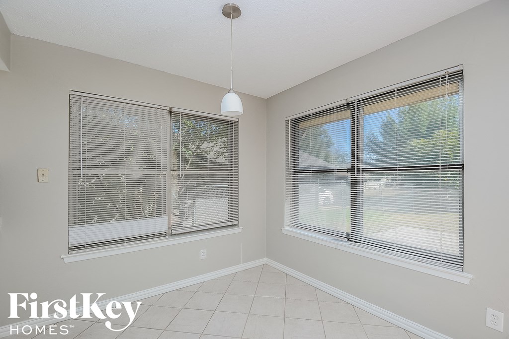 the second bedroom has two windows and a tile floor