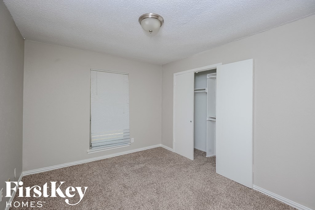 a bedroom with a closet and a door to the bathroom