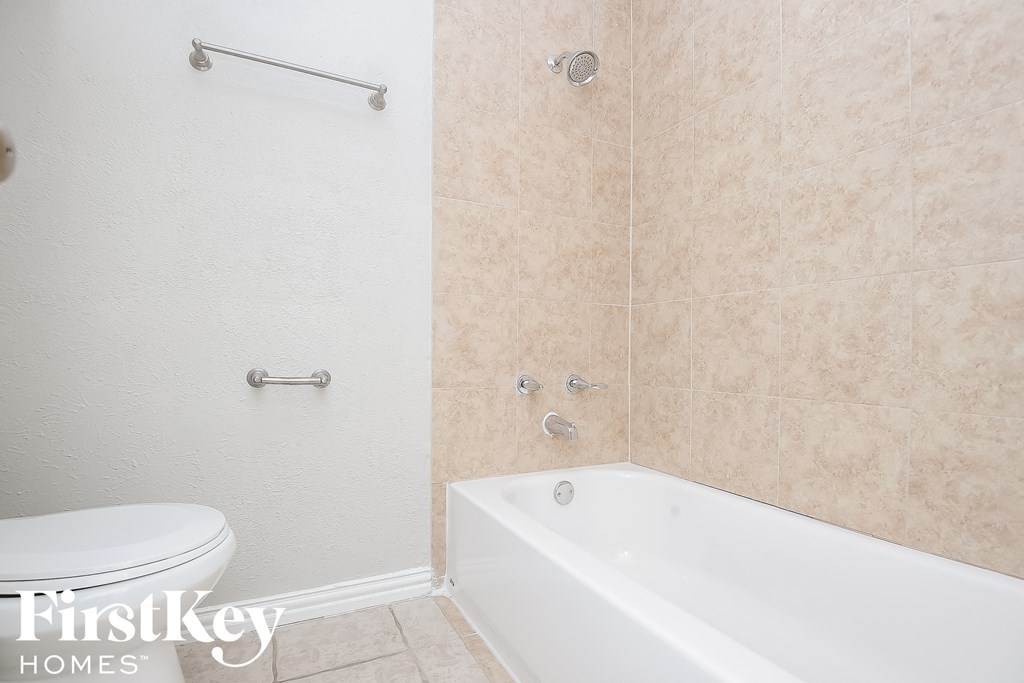 a bathroom with a tub and a toilet and a sink