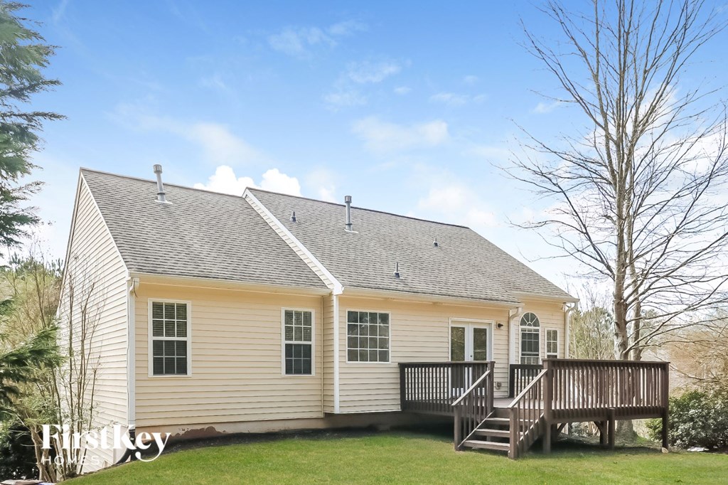 A house with a grey roof and a wooden deck.