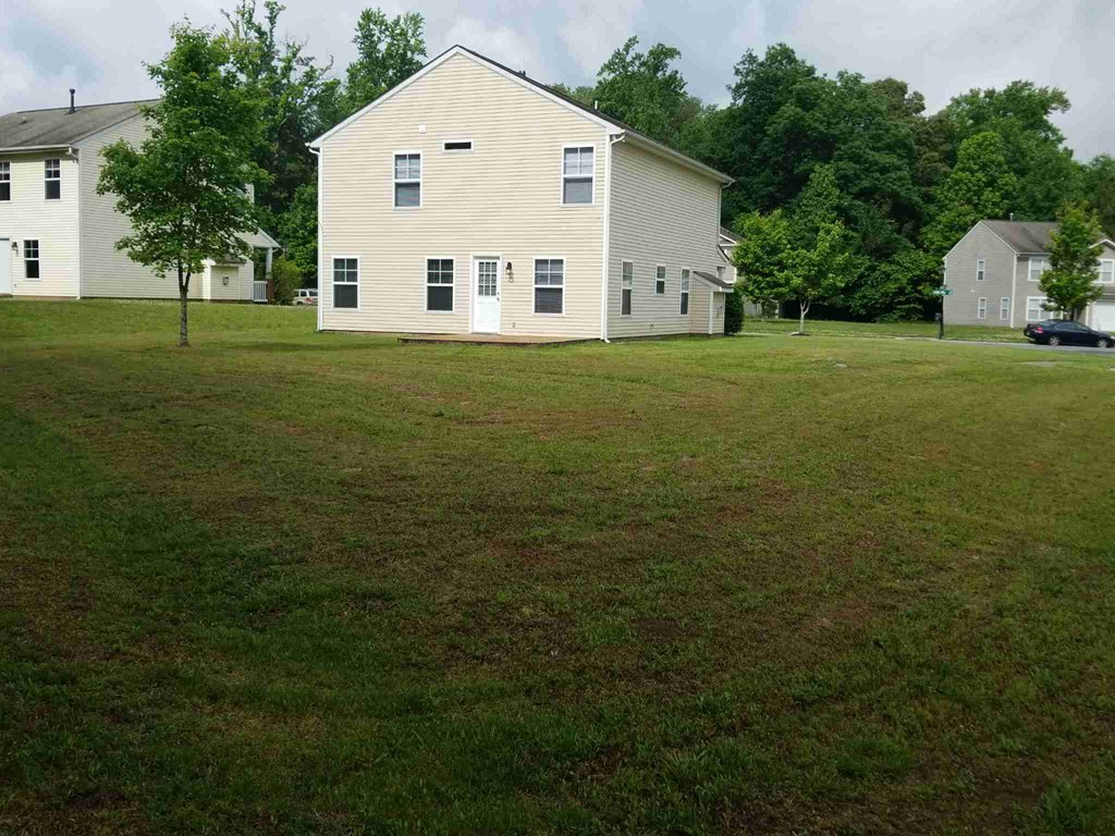 a white house in the middle of a grass field