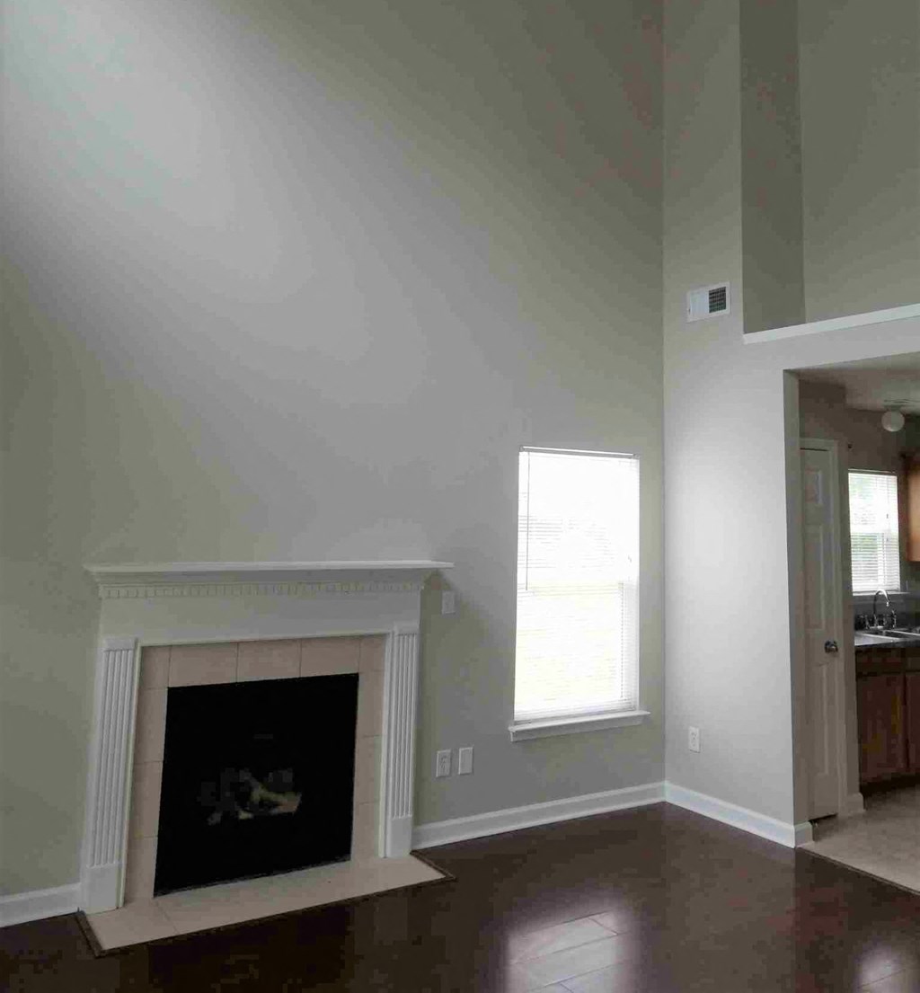 a living room with a fireplace and a door to a bathroom