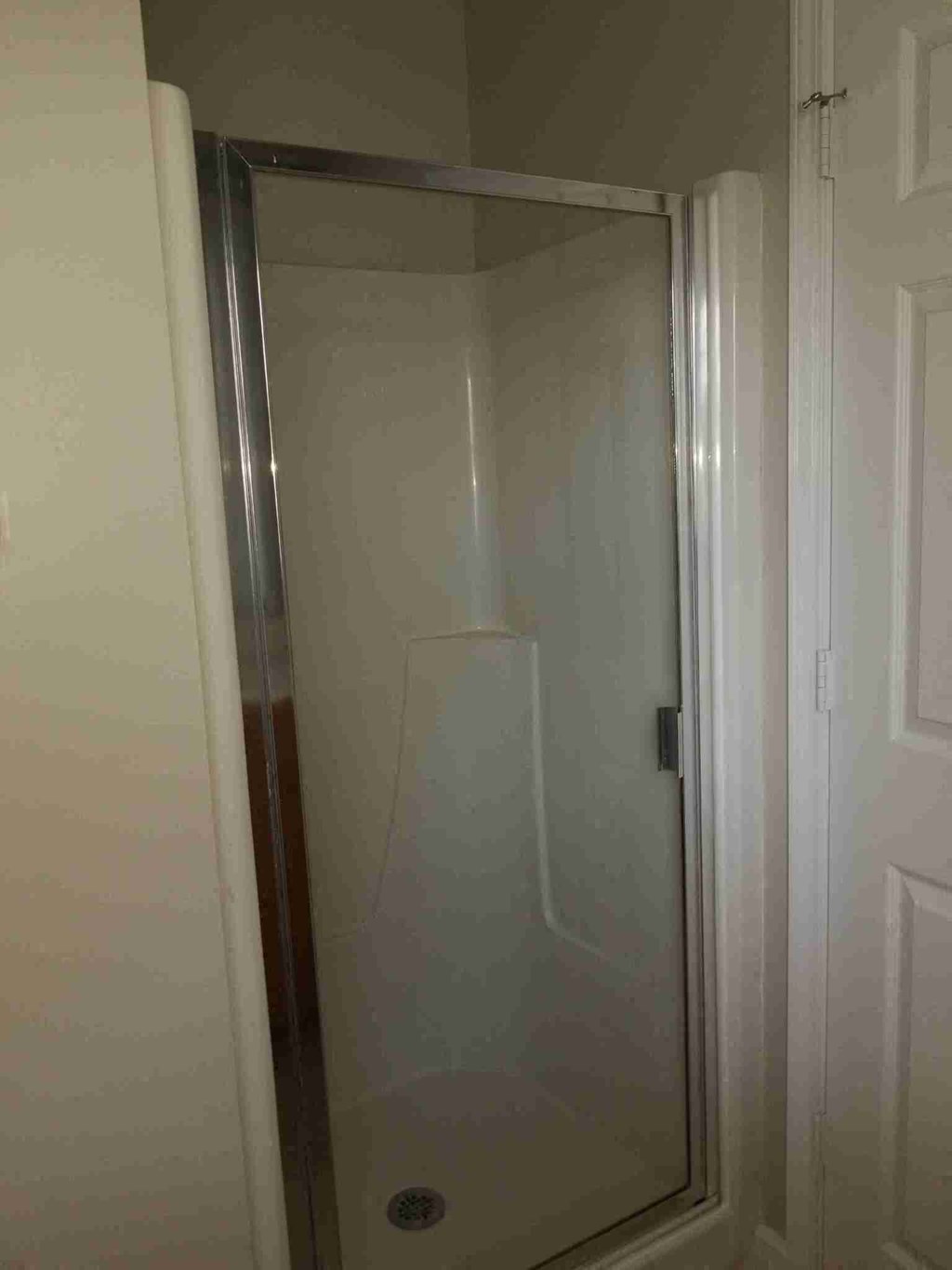 a shower with a glass door in a bathroom