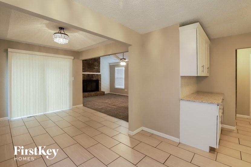 a kitchen and living room with a large door to the living room