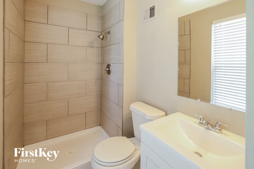 a bathroom with a toilet sink and tub and a shower