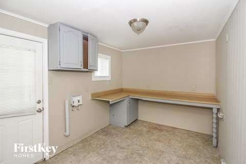 a small kitchen with a counter top and a white cabinet