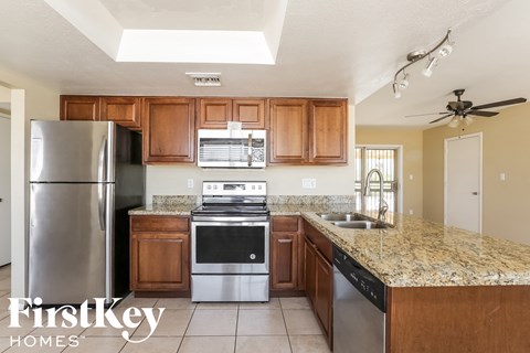 A kitchen with a refrigerator, stove, and oven.