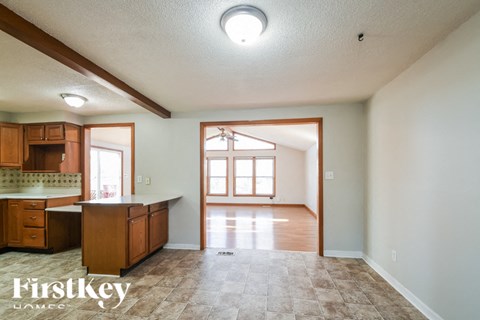 A kitchen with wooden cabinets and a tiled floor.