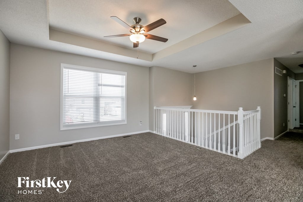 a nursery with a white crib and a ceiling fan
