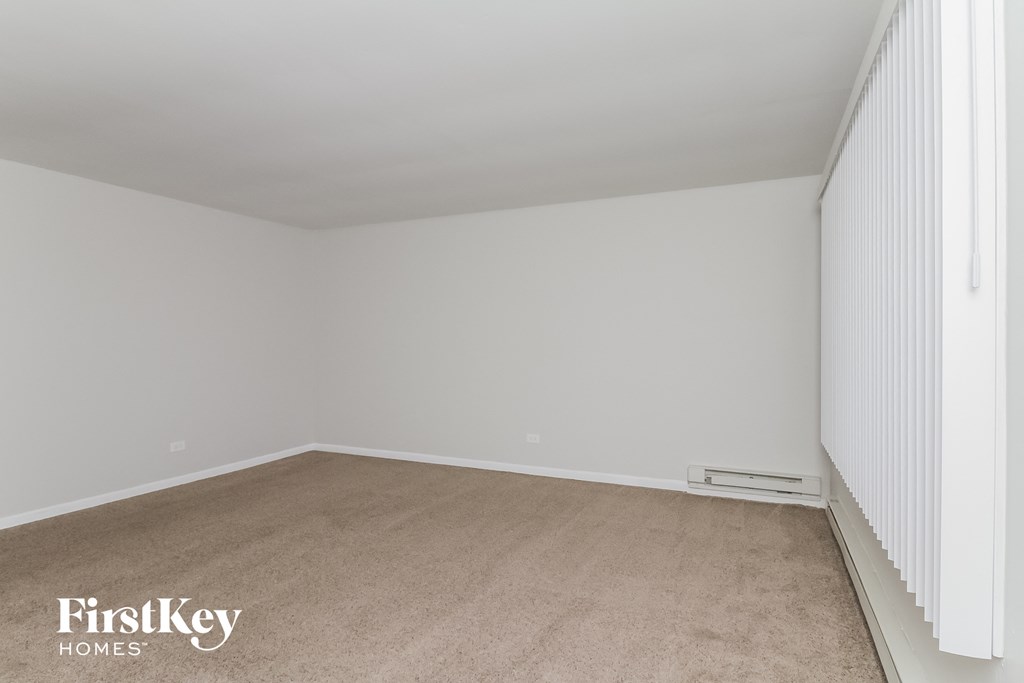 a bedroom with a carpeted floor and white walls