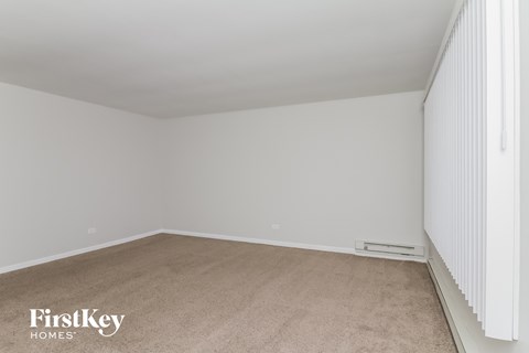 a bedroom with a carpeted floor and white walls