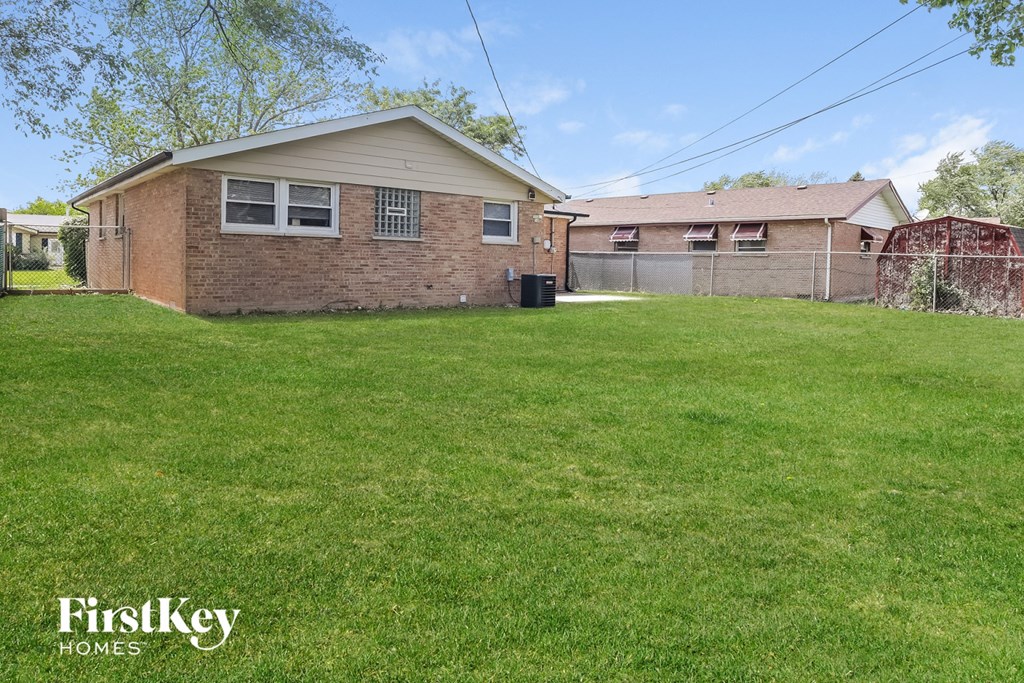 a backyard with a house and a yard with grass