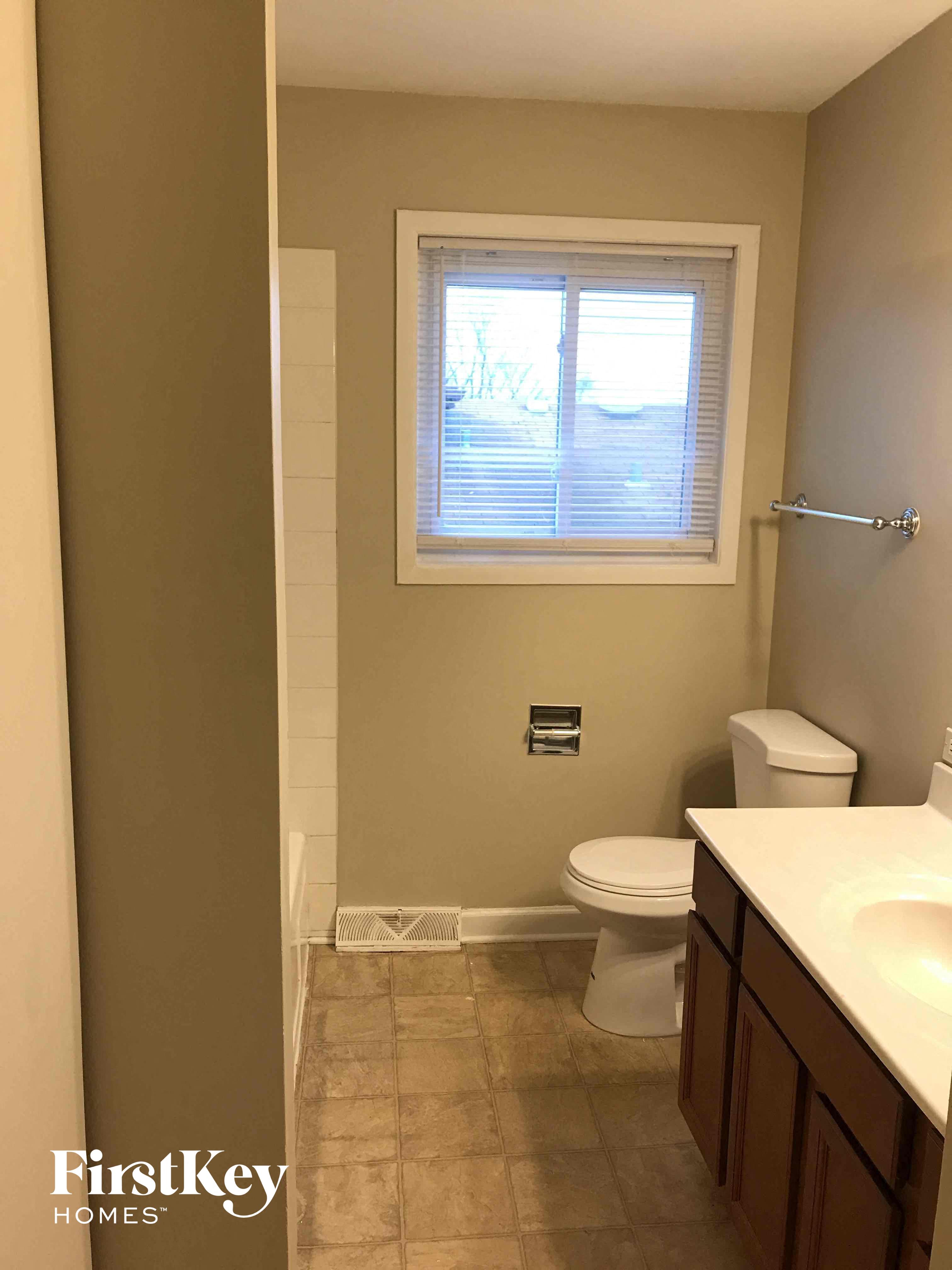 a small bathroom with a toilet and a window