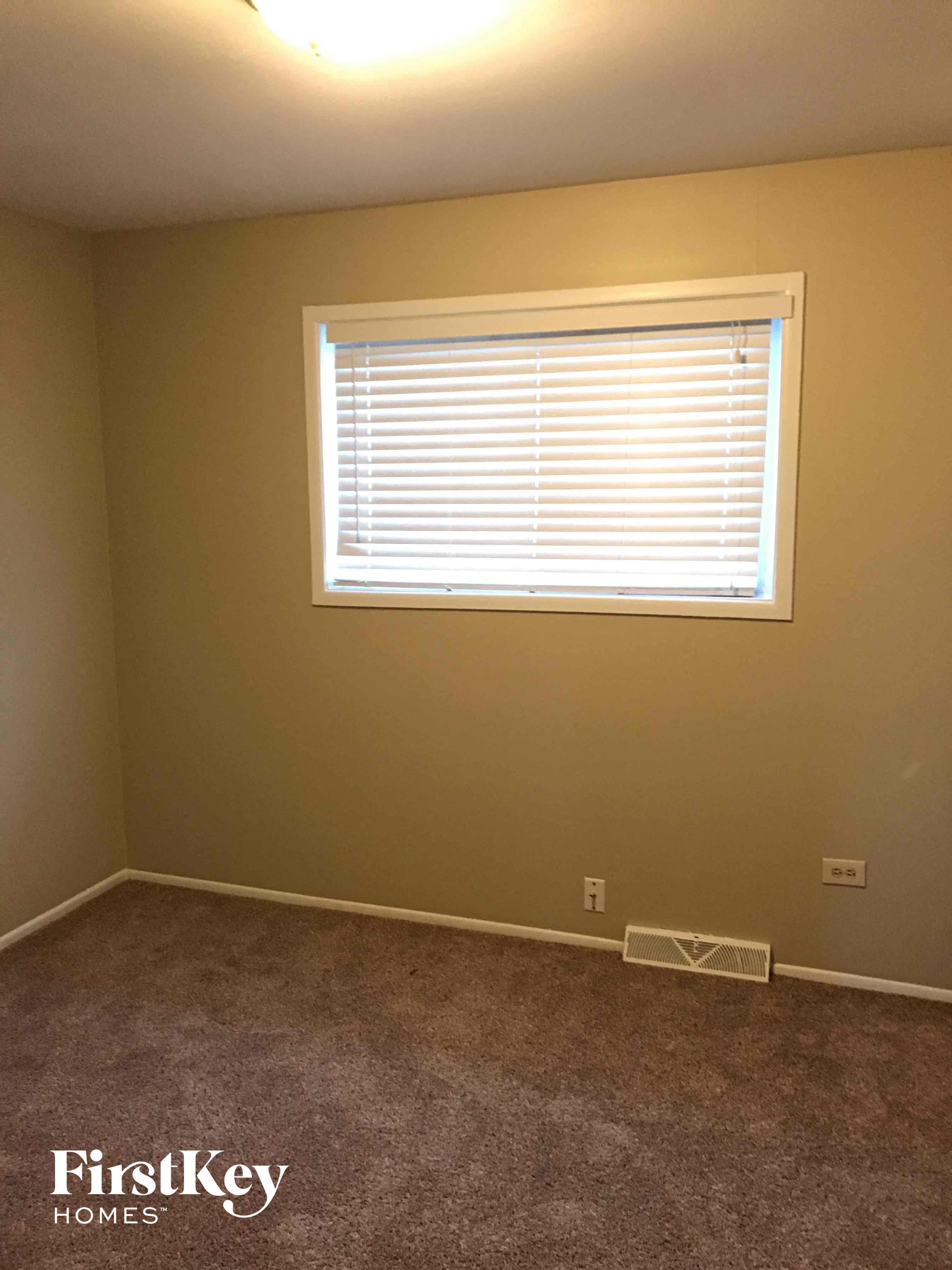a room with a window and a carpet