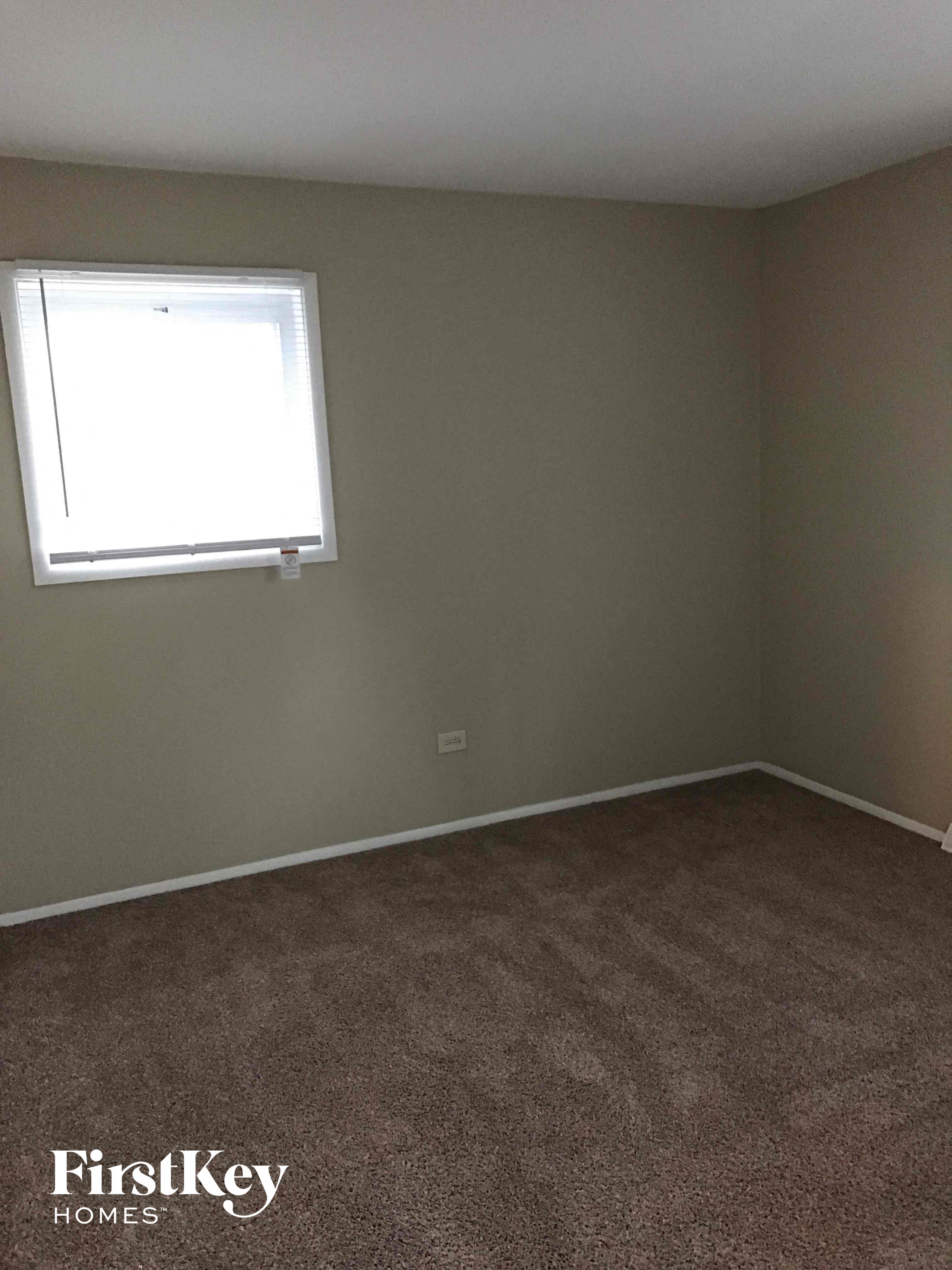 a room with a carpet and a window