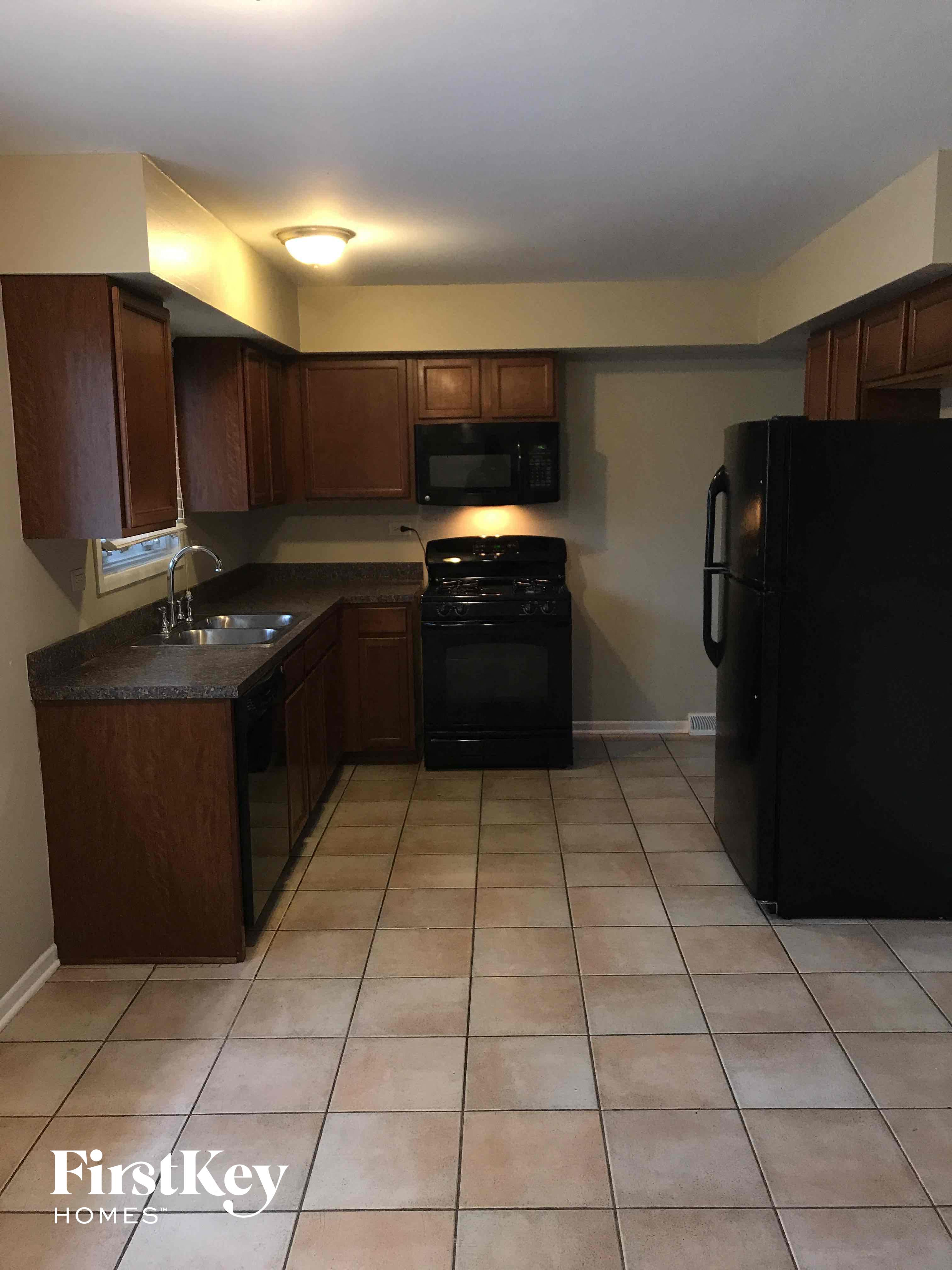 a kitchen with a stove and a sink and a refrigerator