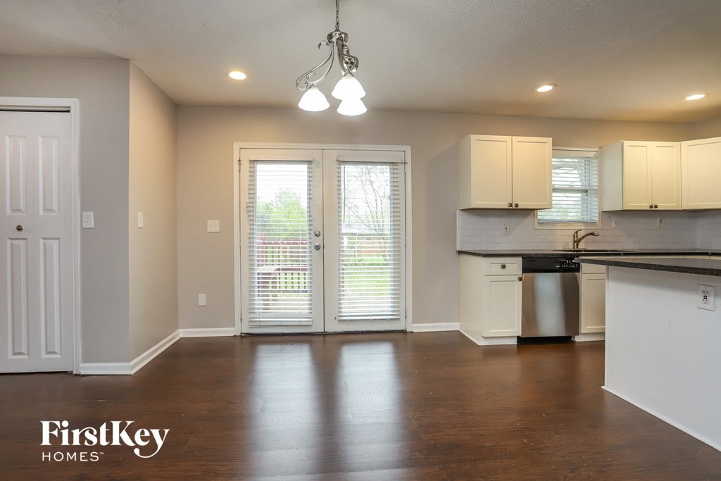 A kitchen with a dishwasher and a fridge.