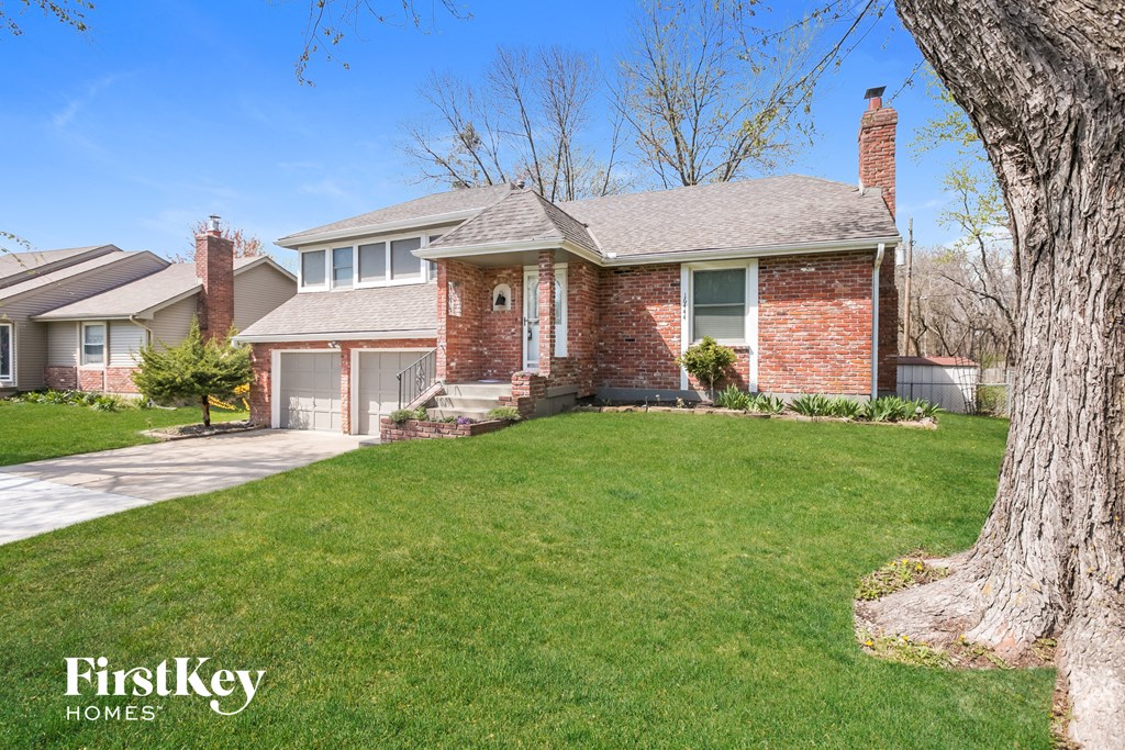 a house with a lawn and a tree