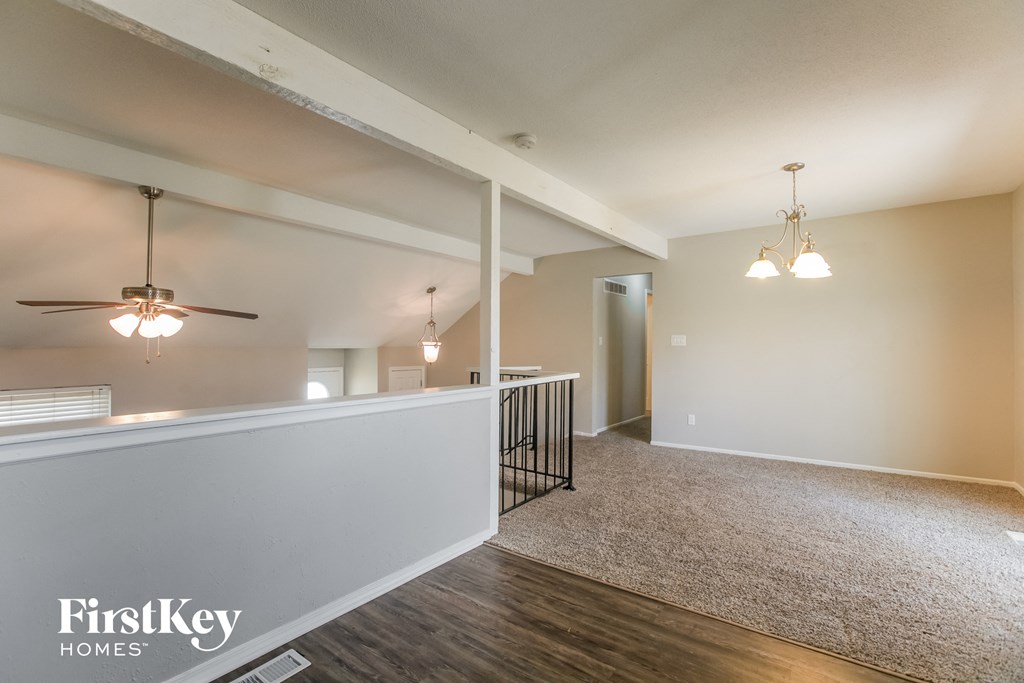 the living room and dining room of an open floor plan